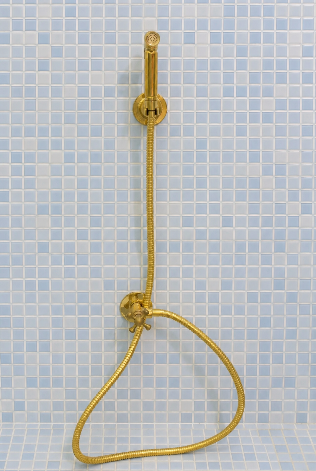 Handmade solid brass wall-mounted handheld bidet sprayer with flexible brass hose and integrated shut-off valve.