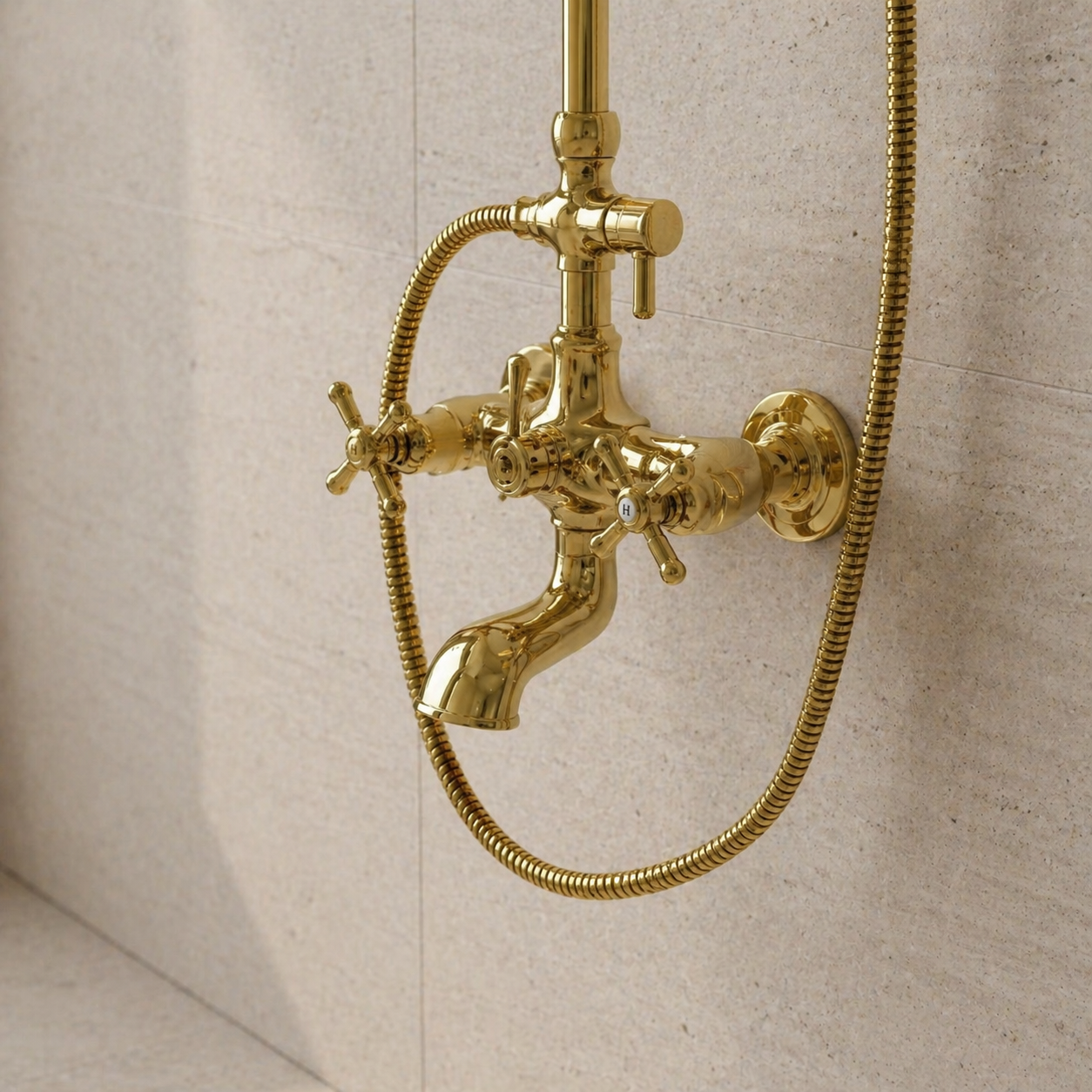 Handcrafted unlacquered antique brass exposed shower system featuring rainfall shower head, handheld shower, cross handles, and integrated tub faucet in a luxury modern bathroom