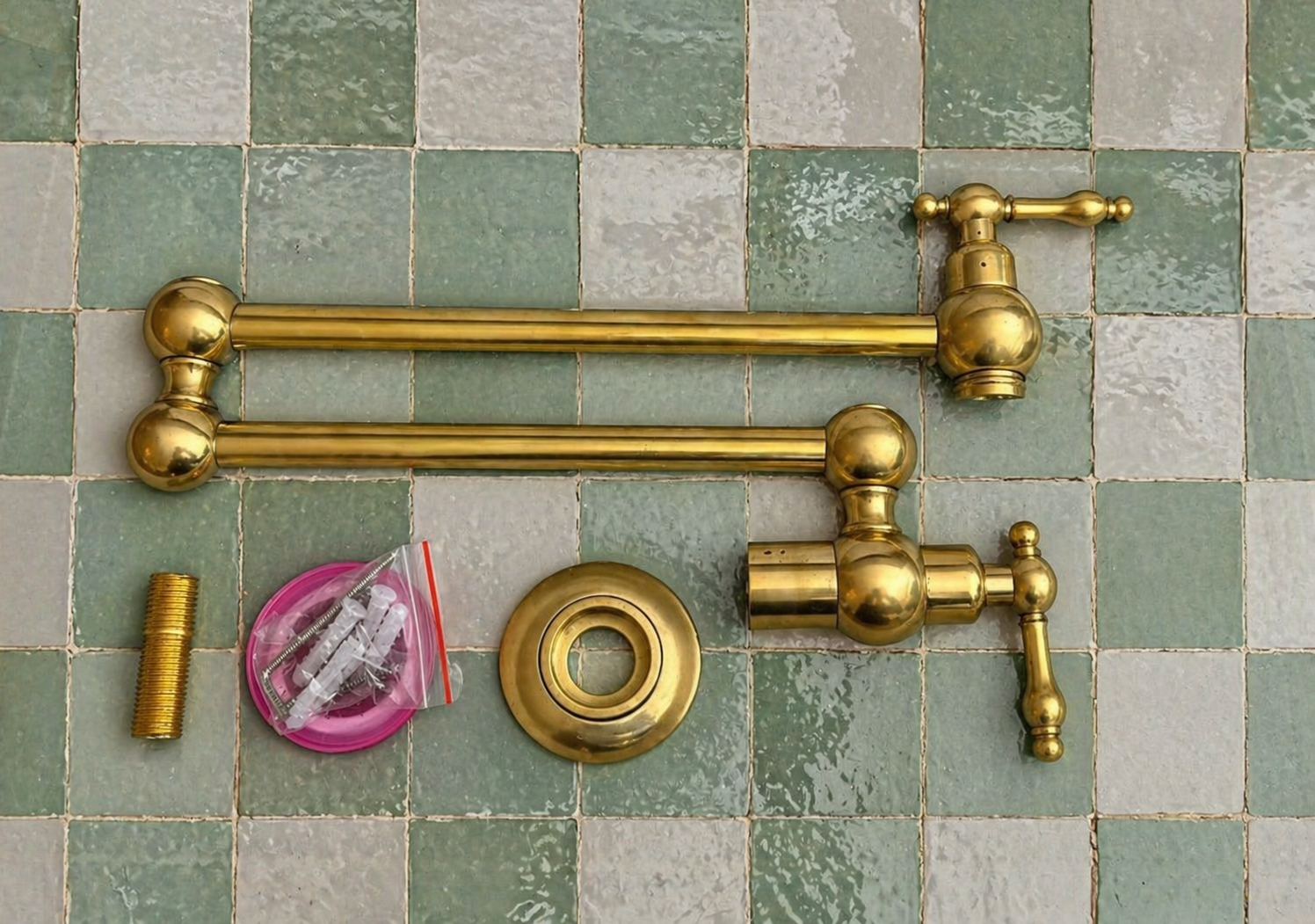 Handmade solid brass wall-mounted pot filler faucet with dual swing arms and unlacquered living brass finish installed above a kitchen stove.
