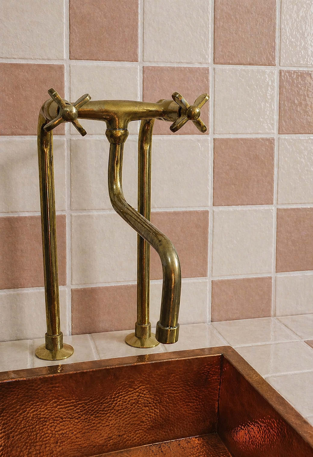 Tall unlacquered brass bridge kitchen faucet with long linear legs, cross handles and curved spout