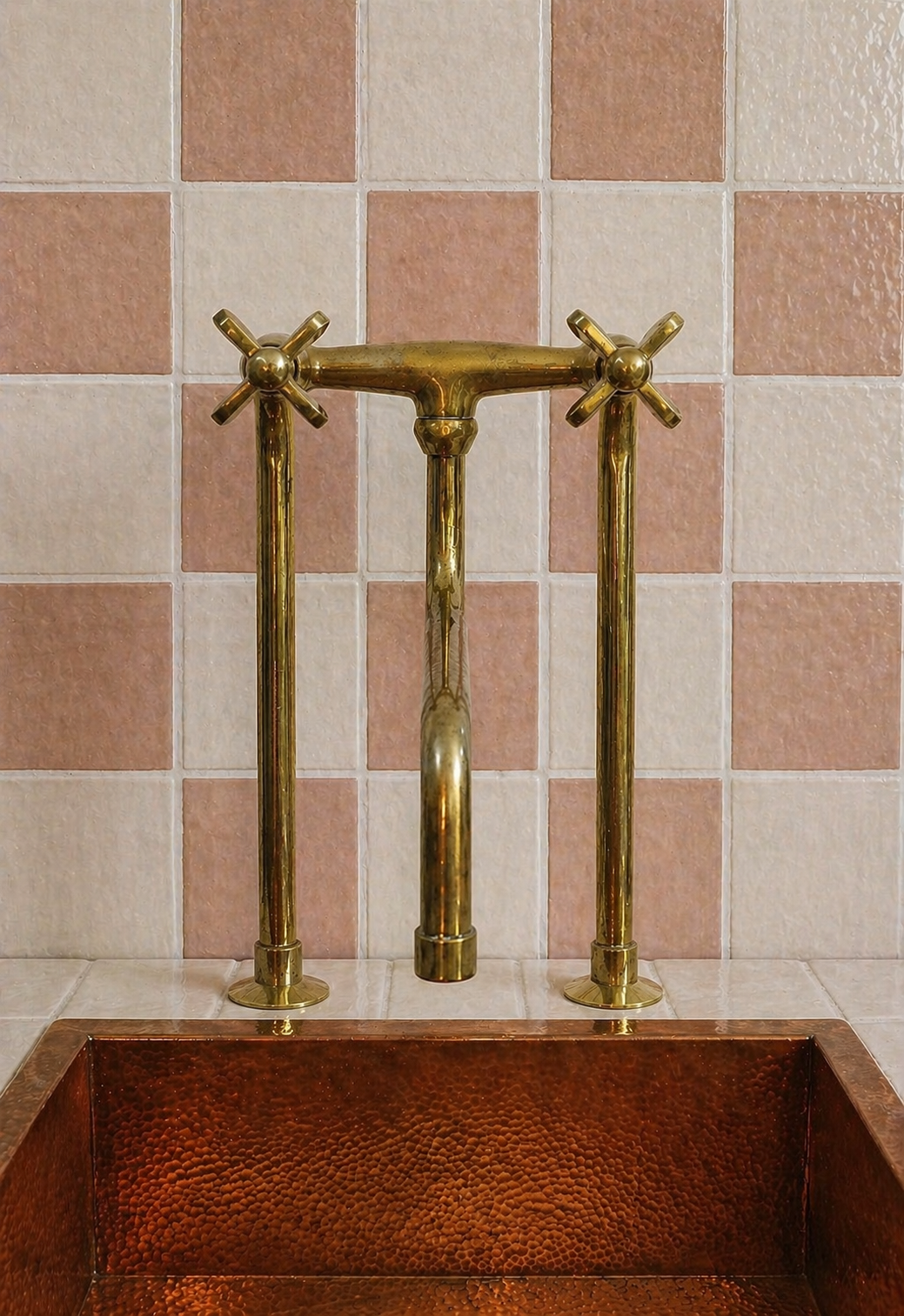 Tall unlacquered brass bridge kitchen faucet with long linear legs, cross handles and curved spout