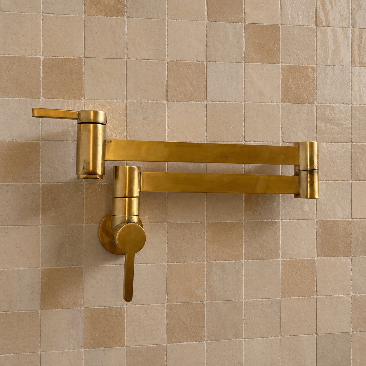 Modern handmade unlacquered solid brass wall-mounted pot filler faucet with dual swing arms and minimalist design for luxury kitchens.