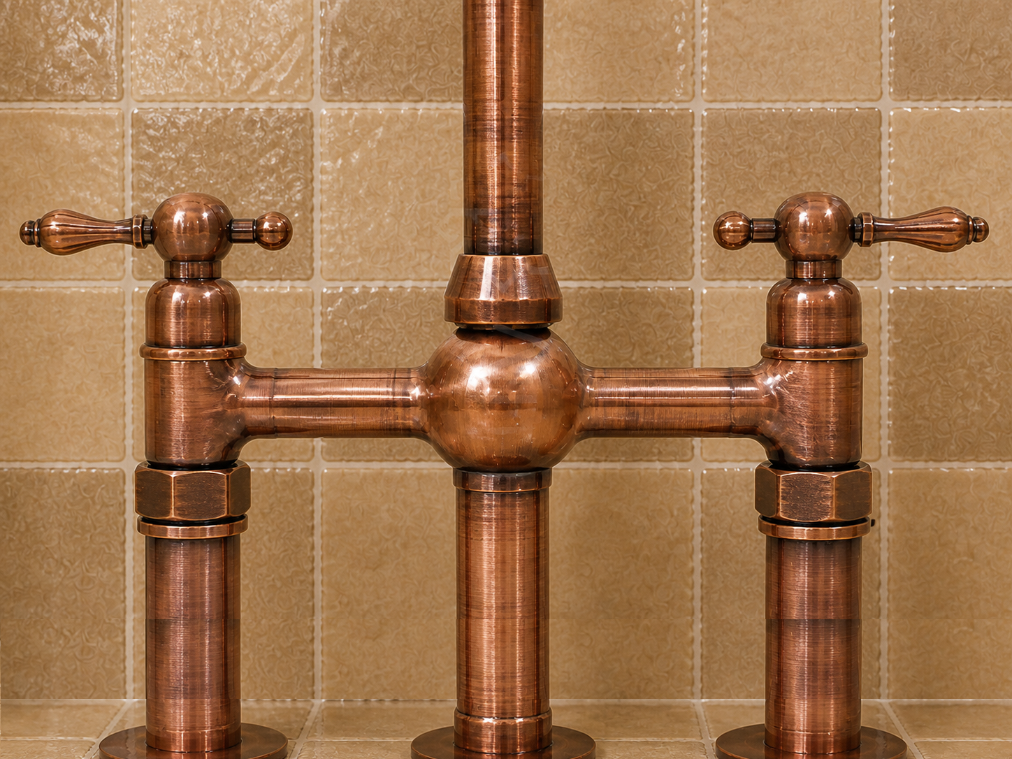 A traditional copper bridge faucet with two cross handles and polished cylindrical posts, set against a beige tiled wall.