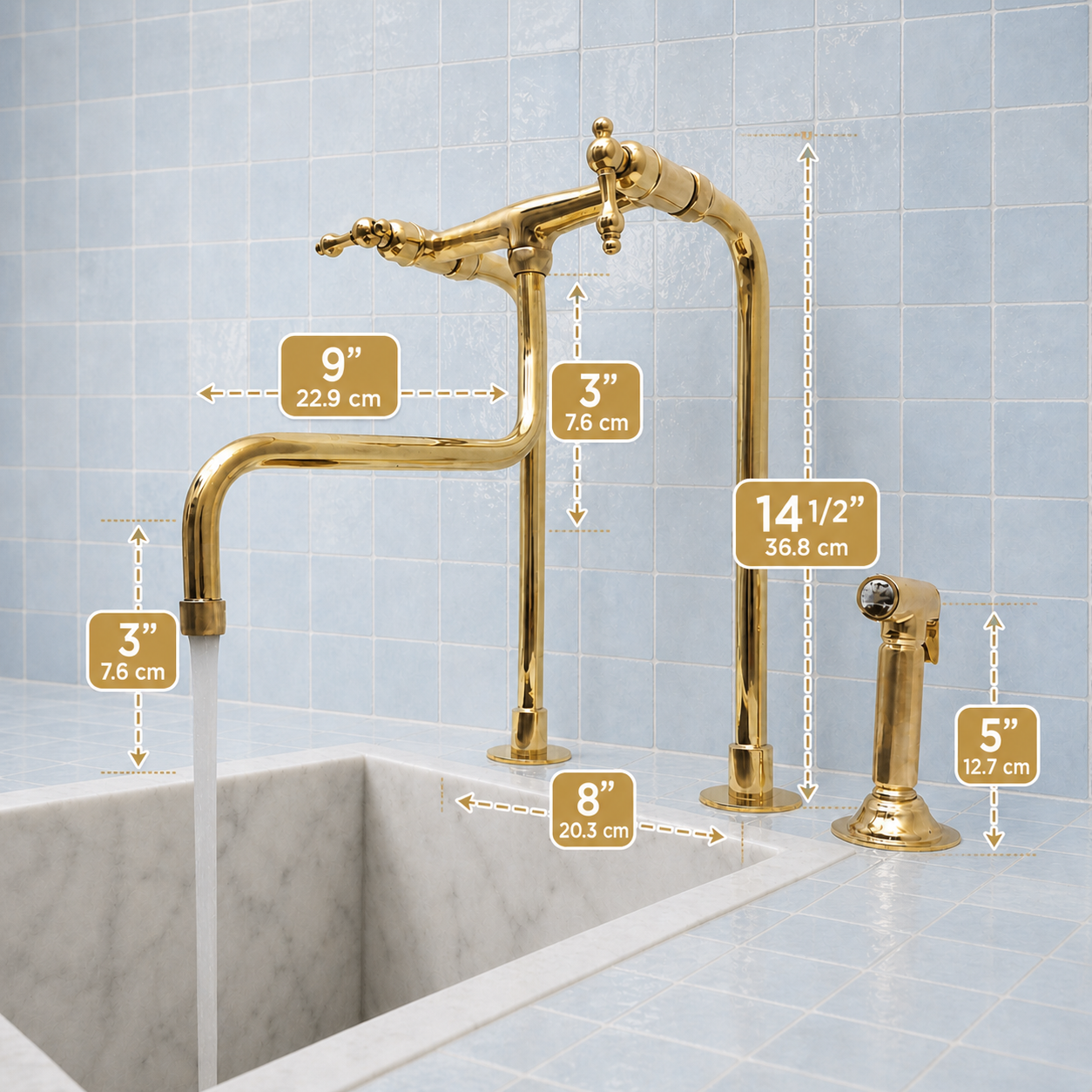 Gold faucet set with dimension callouts over a marble sink against pale blue tiled walls. The image shows the faucet spout, tall riser, side handle, and spray head with measurements in inches and centimeters.