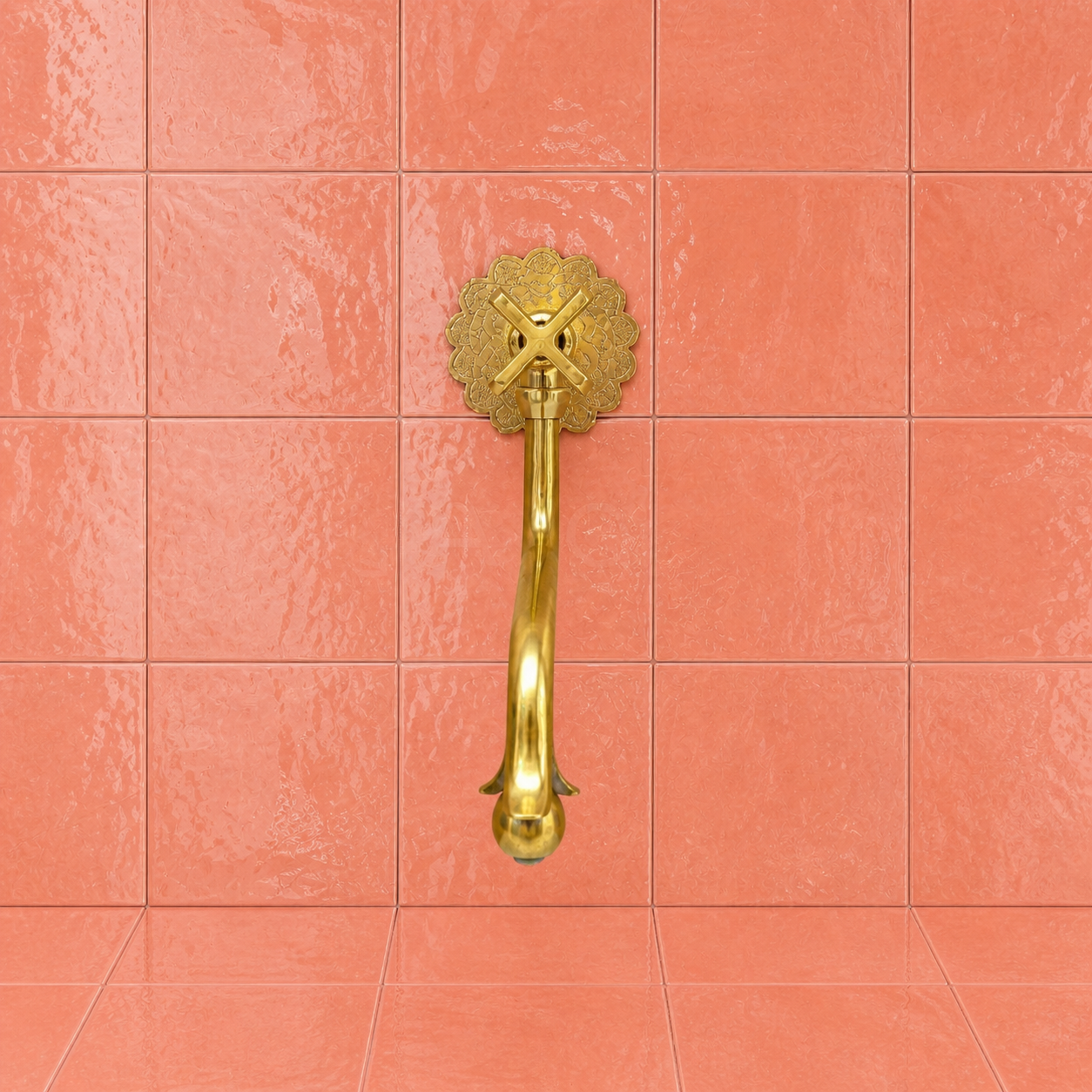 Handmade unlacquered solid brass wall-mounted pot filler faucet with curved swan-neck spout and engraved Moroccan decorative backplate.