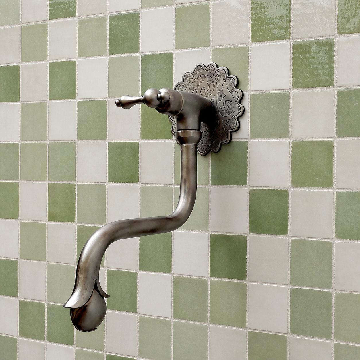 Handmade brushed nickel solid brass wall-mounted pot filler faucet with decorative Moroccan engraved backplate and curved swivel spout.