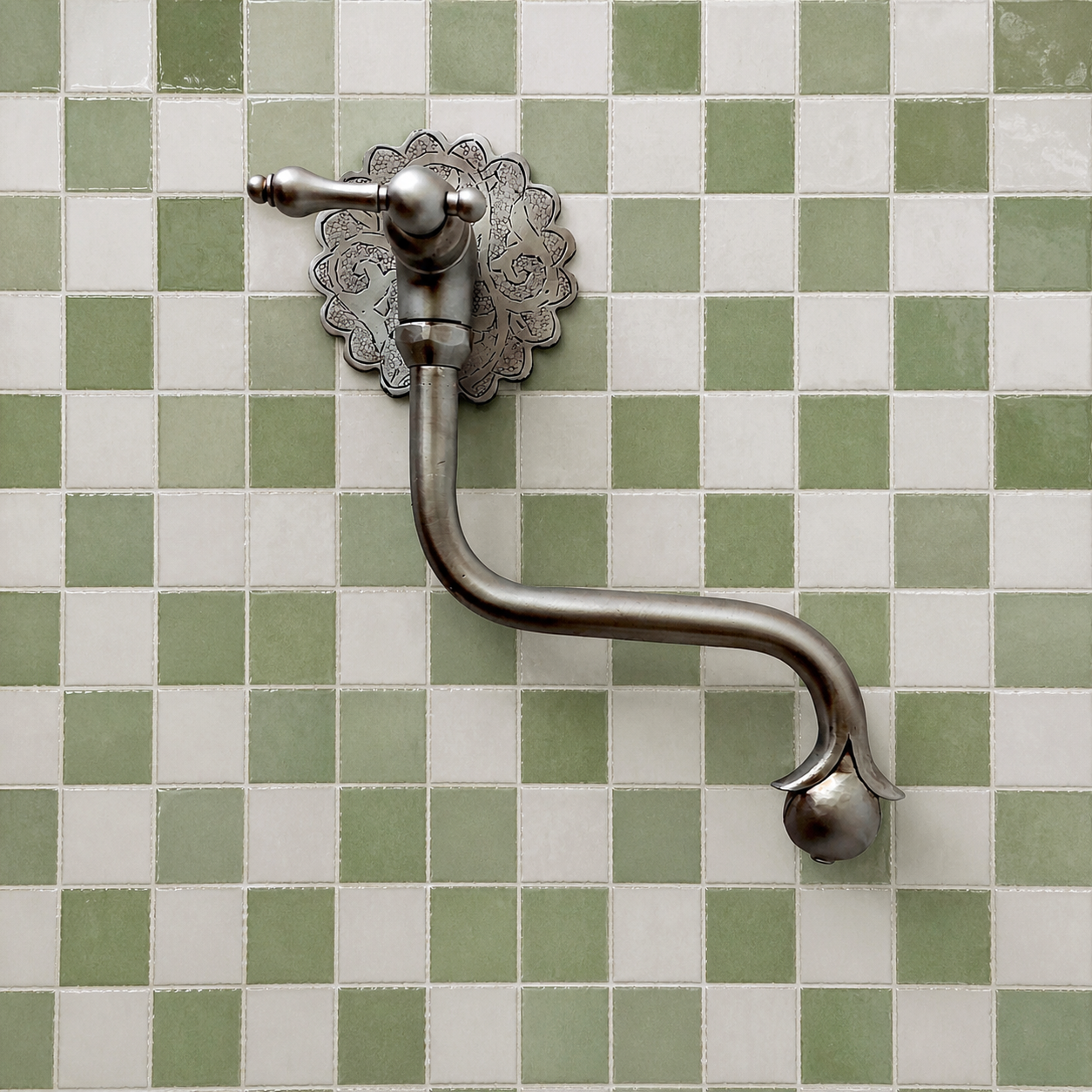 Handmade brushed nickel solid brass wall-mounted pot filler faucet with decorative Moroccan engraved backplate and curved swivel spout.