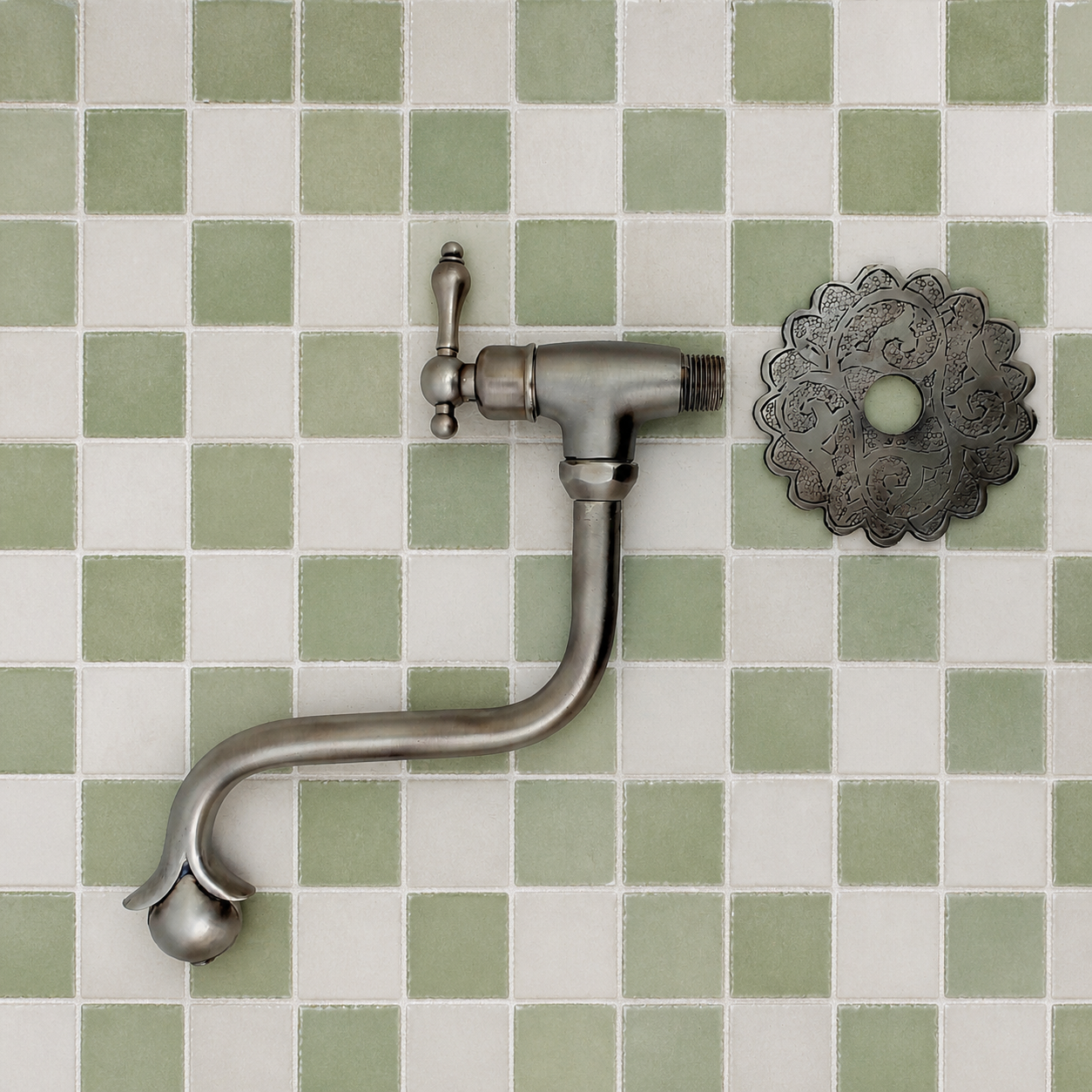 Handmade brushed nickel solid brass wall-mounted pot filler faucet with decorative Moroccan engraved backplate and curved swivel spout.