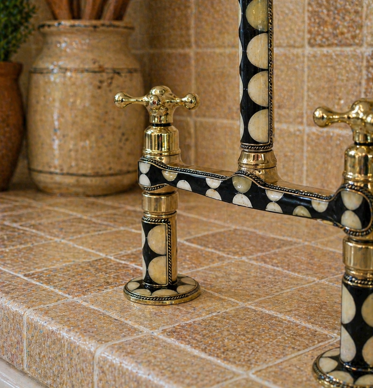 Close-up of handmade brass bridge kitchen faucet with black and bone resin detailing