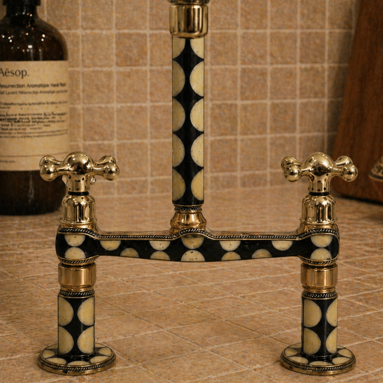 Detailed view of handcrafted brass bridge faucet body with black and bone resin inlay and cross handles