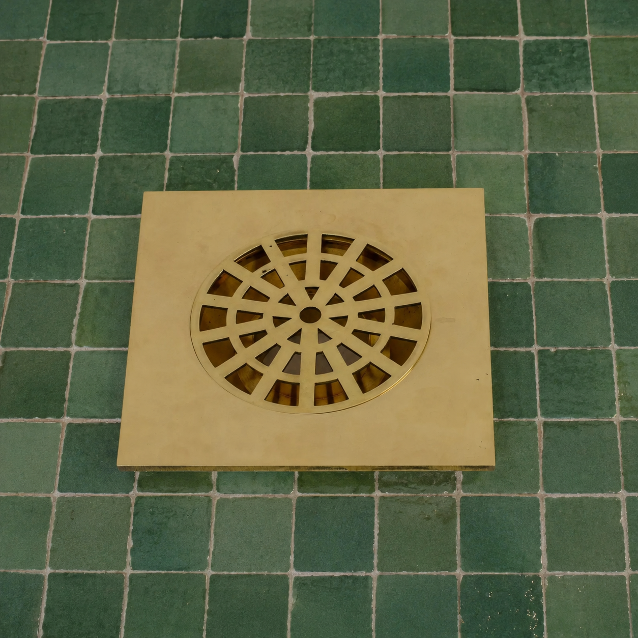 Handmade Moroccan solid brass square shower drain cover with decorative geometric cutout pattern and polished brass finish.