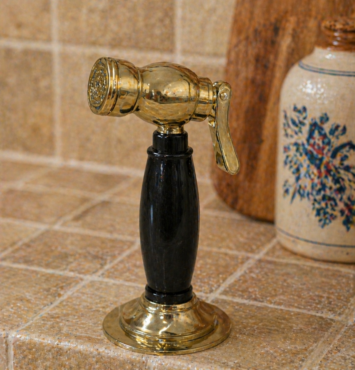 Solid brass kitchen side sprayer with black resin handle and polished brass finish