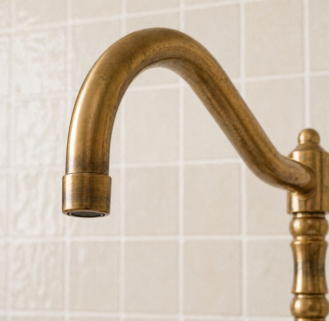 Unlacquered brass bridge kitchen faucet with cross handles and matching handheld side sprayer