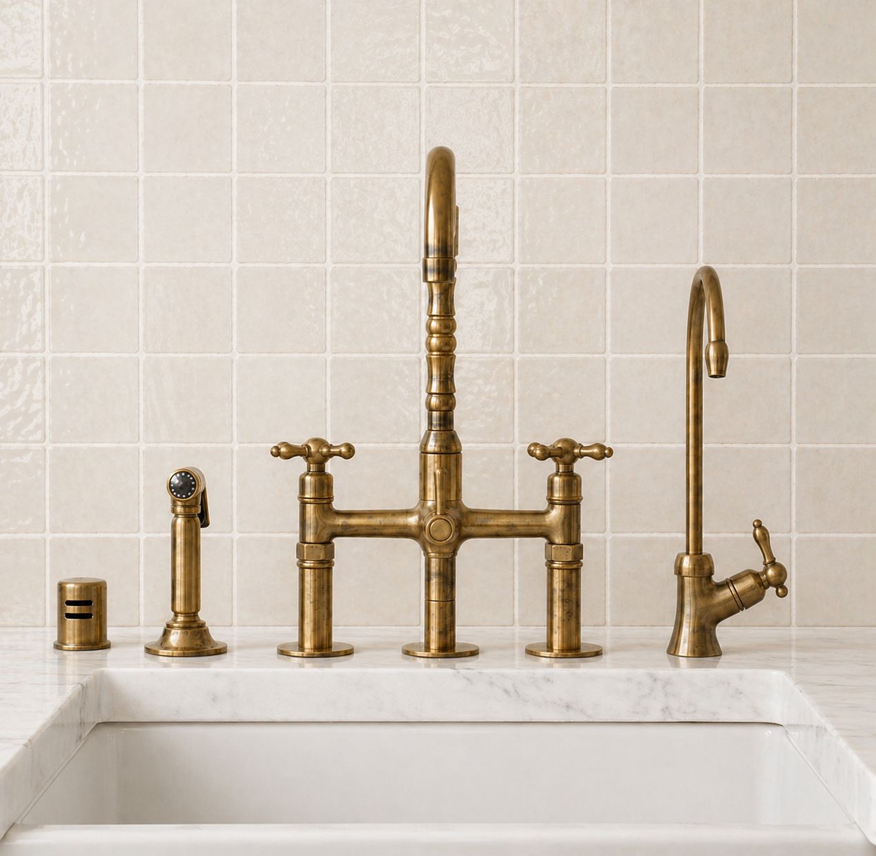Unlacquered brass bridge kitchen faucet with cross handles and matching handheld side sprayer