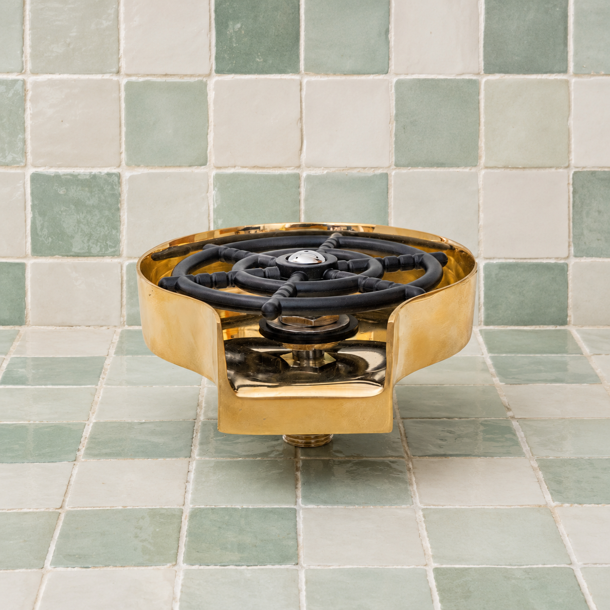 Handmade solid brass glass rinser with unlacquered finish installed for rinsing cups, bottles, mugs, and drinkware.