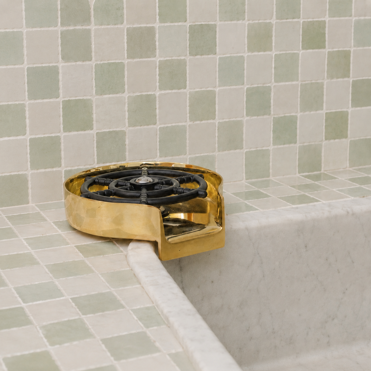 Handmade solid brass glass rinser with unlacquered finish installed for rinsing cups, bottles, mugs, and drinkware.