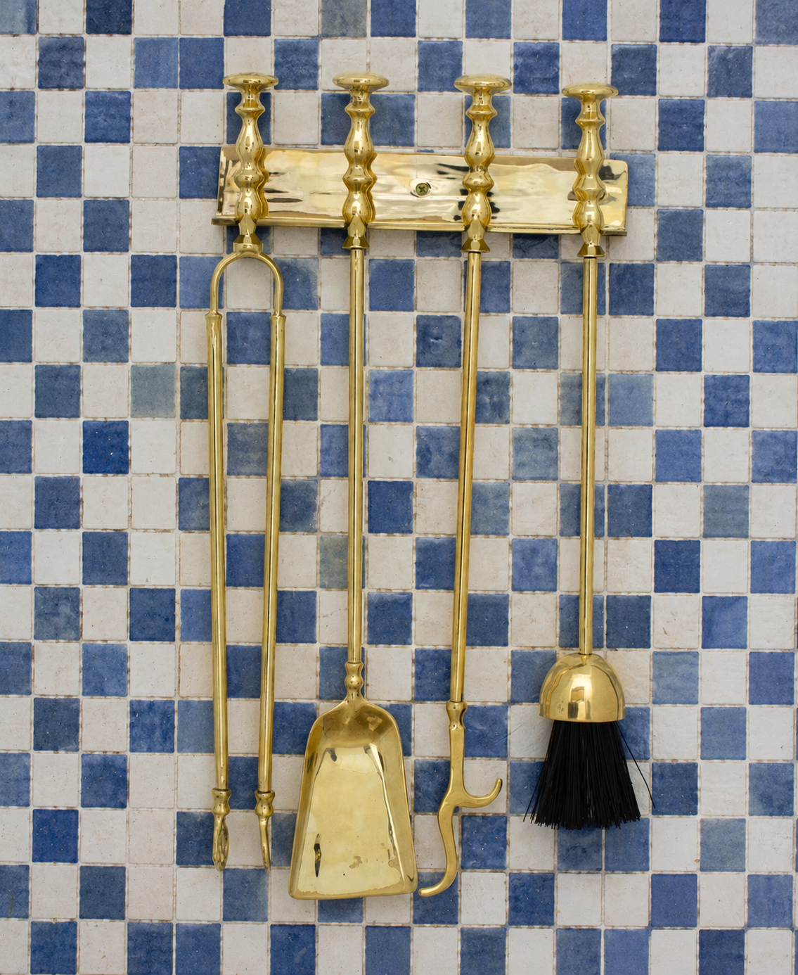 Handmade solid brass wall-mounted fireplace tool set with poker, tongs, ash shovel, brush, and storage rack.