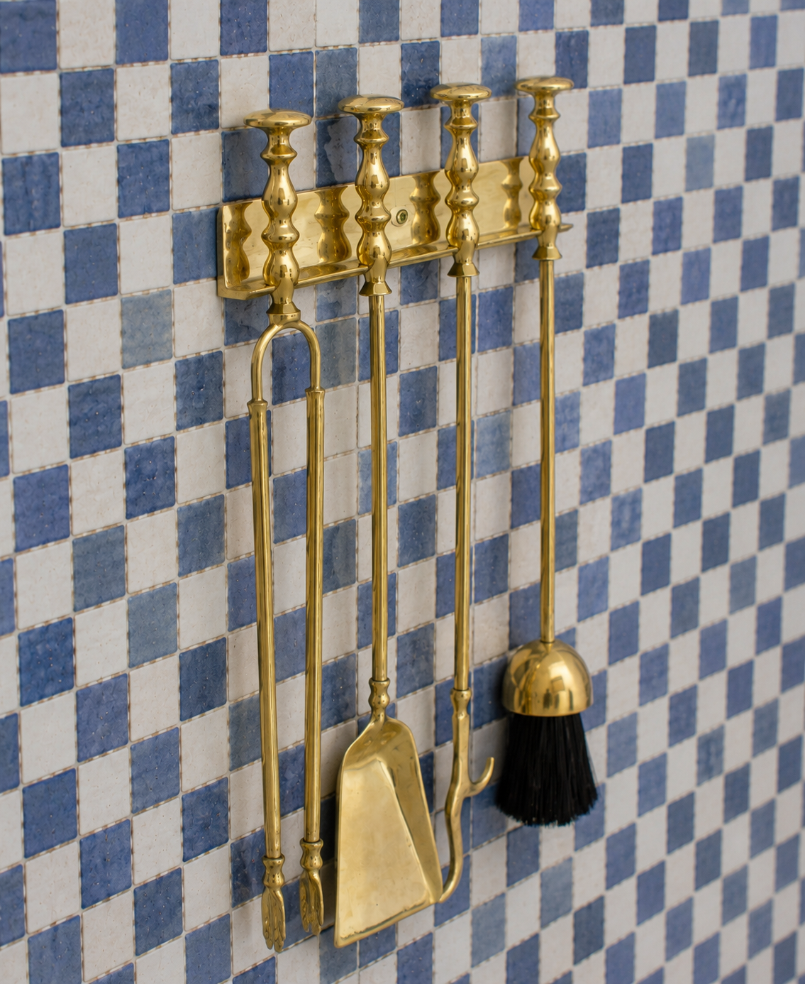 Handmade solid brass wall-mounted fireplace tool set with poker, tongs, ash shovel, brush, and storage rack.