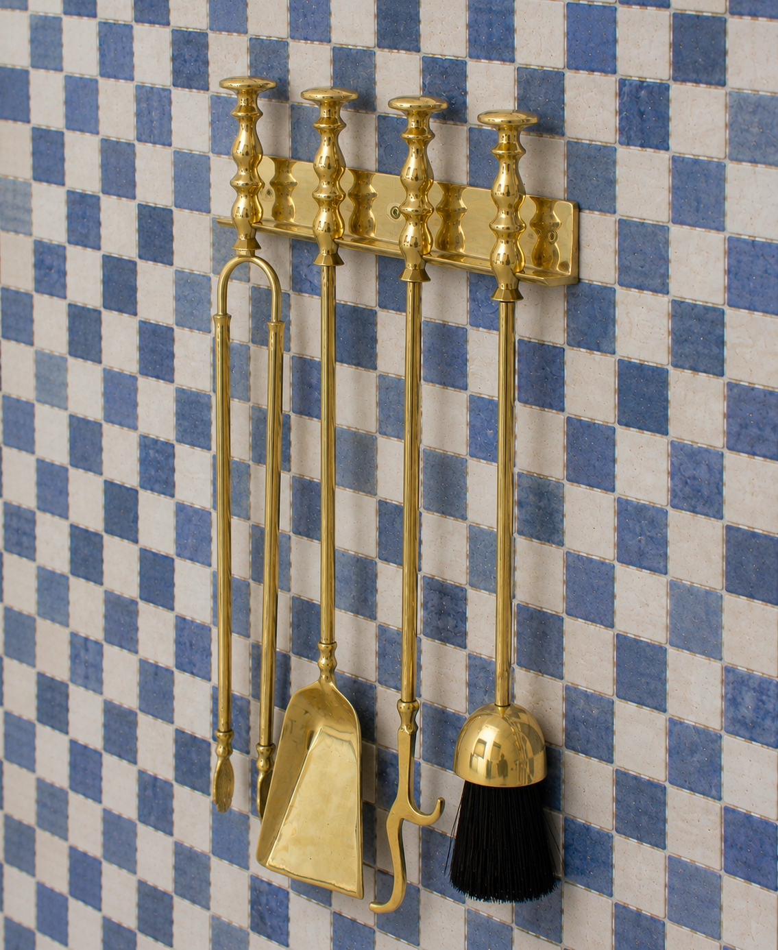 Handmade solid brass wall-mounted fireplace tool set with poker, tongs, ash shovel, brush, and storage rack.