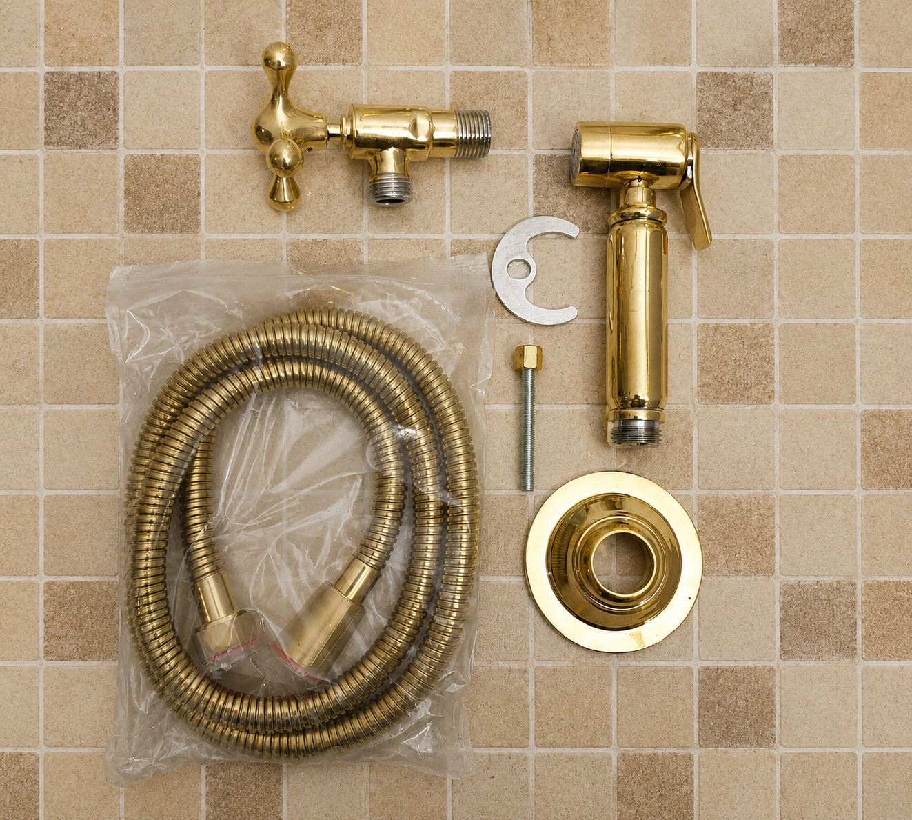 Handmade solid brass kitchen side sprayer with unlacquered finish and shut-off handle installed beside a kitchen faucet.