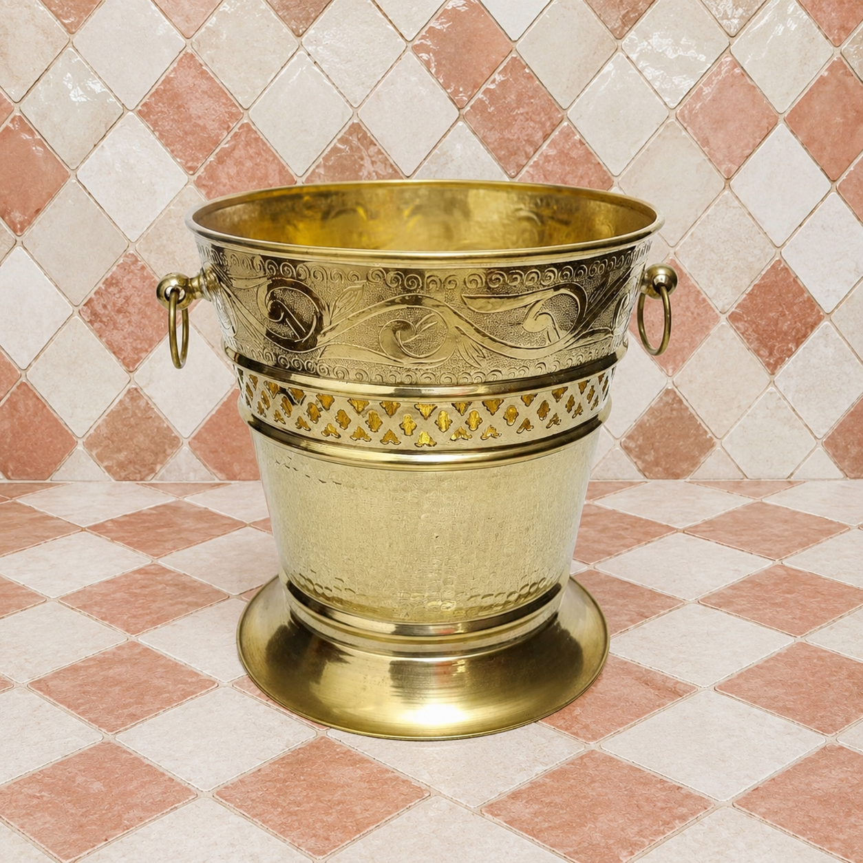 Handmade unlacquered solid brass Moroccan wastebasket with engraved decorative details and side ring handles.