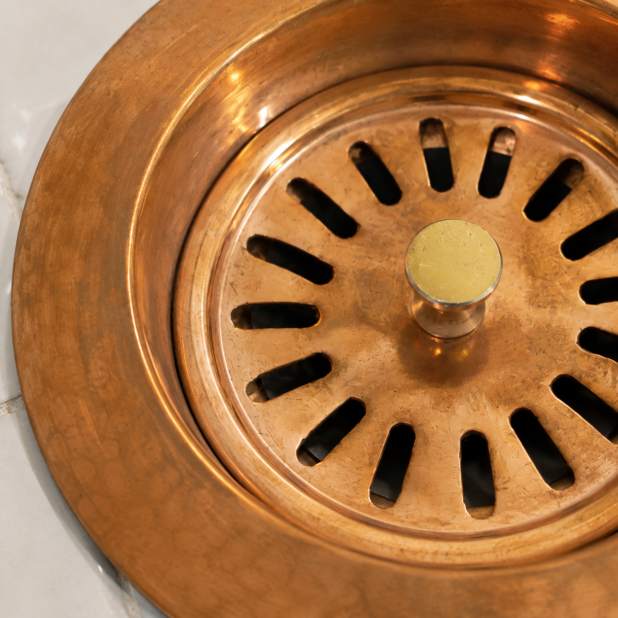 Handmade solid copper kitchen sink strainer basket drain assembly with removable basket for farmhouse and copper kitchen sinks.