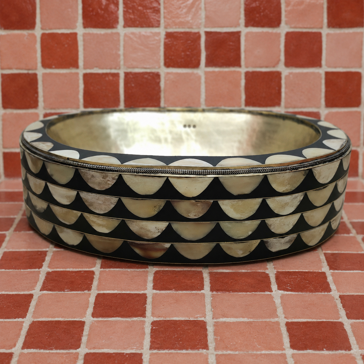 Handmade Moroccan oval bathroom vessel sink with hammered brass basin and black resin and natural bone inlay exterior