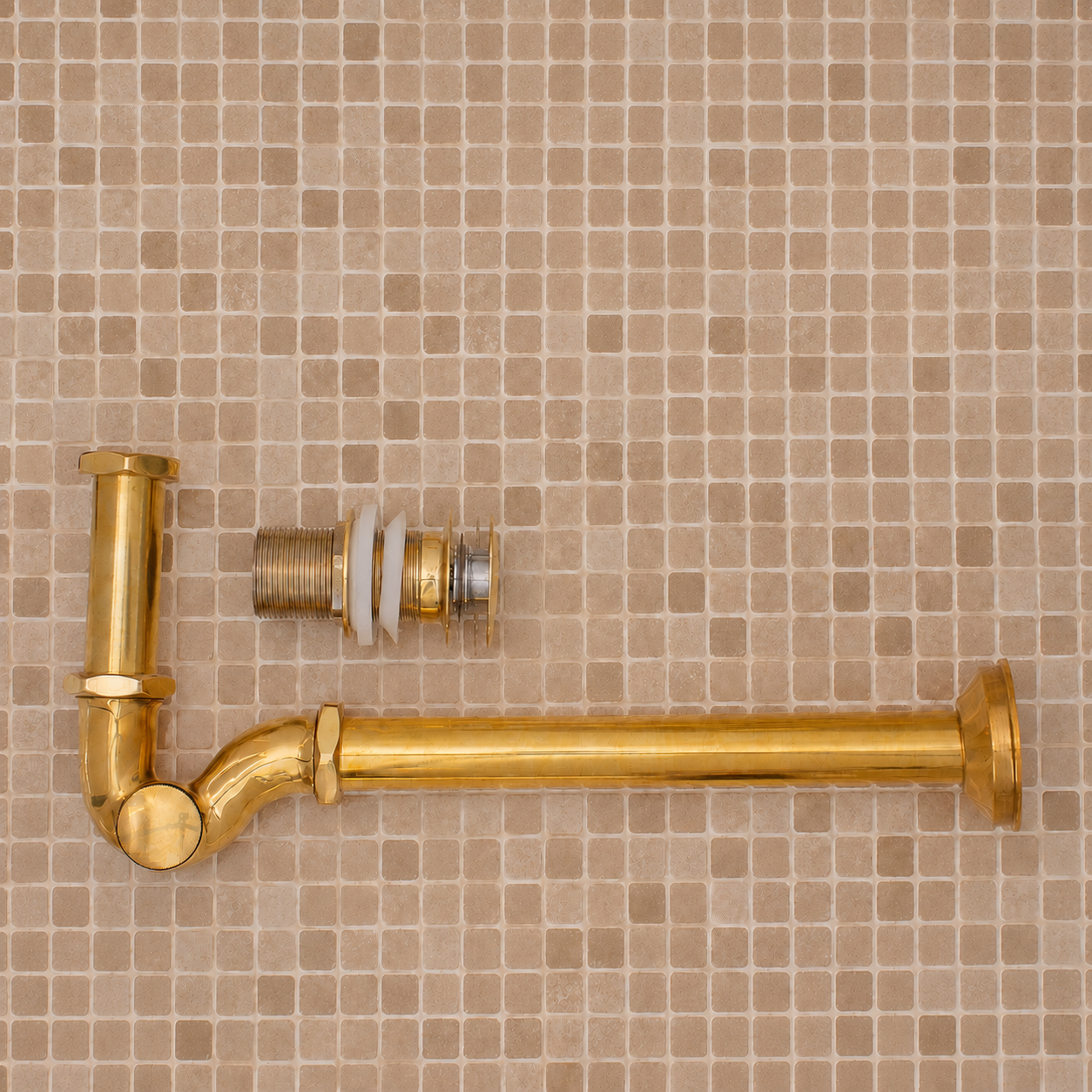 Solid unlacquered brass bathroom sink P-trap and push-button pop-up drain assembly with matching exposed plumbing components.
