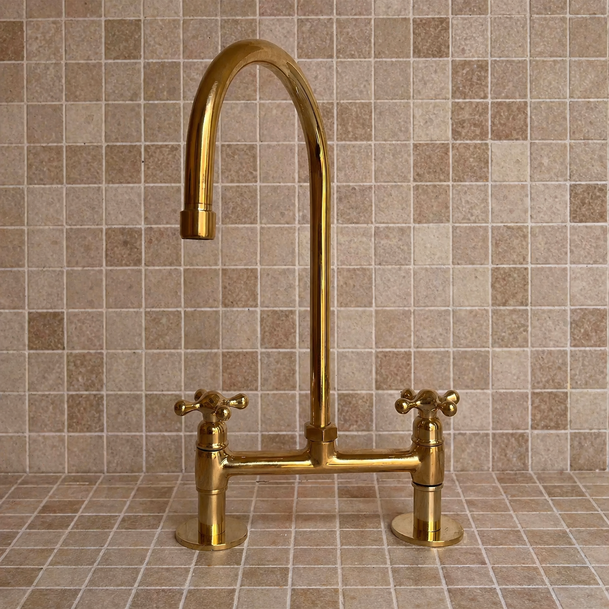 Unlacquered brass bridge kitchen faucet with cross handles and tall high-arc gooseneck spout