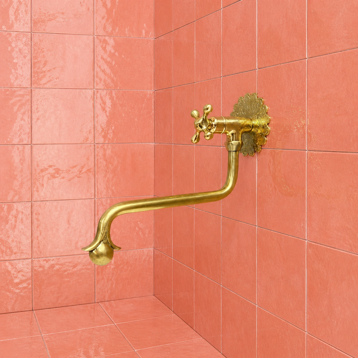 Handmade unlacquered solid brass wall-mounted pot filler faucet with curved swan-neck spout and engraved Moroccan decorative backplate.